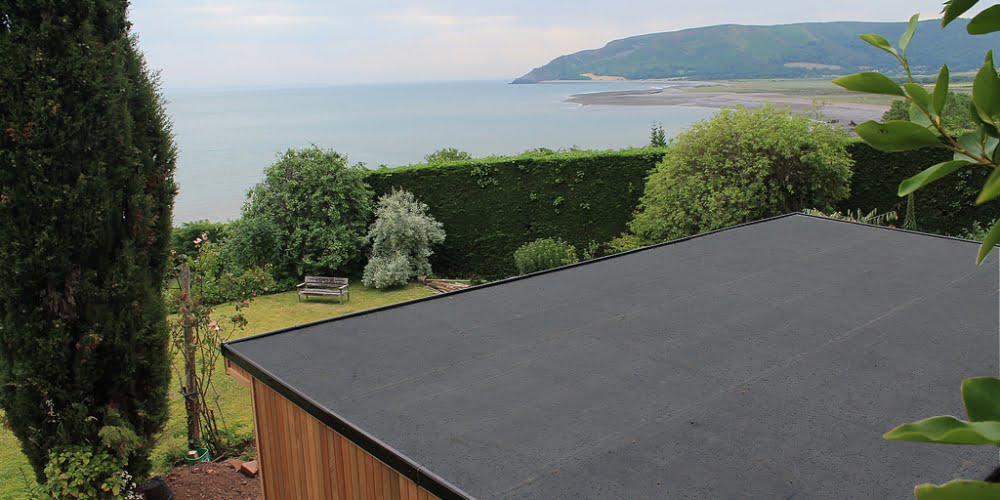 Rubber roofing kit installation to garden outbuilding in coastal surroundings